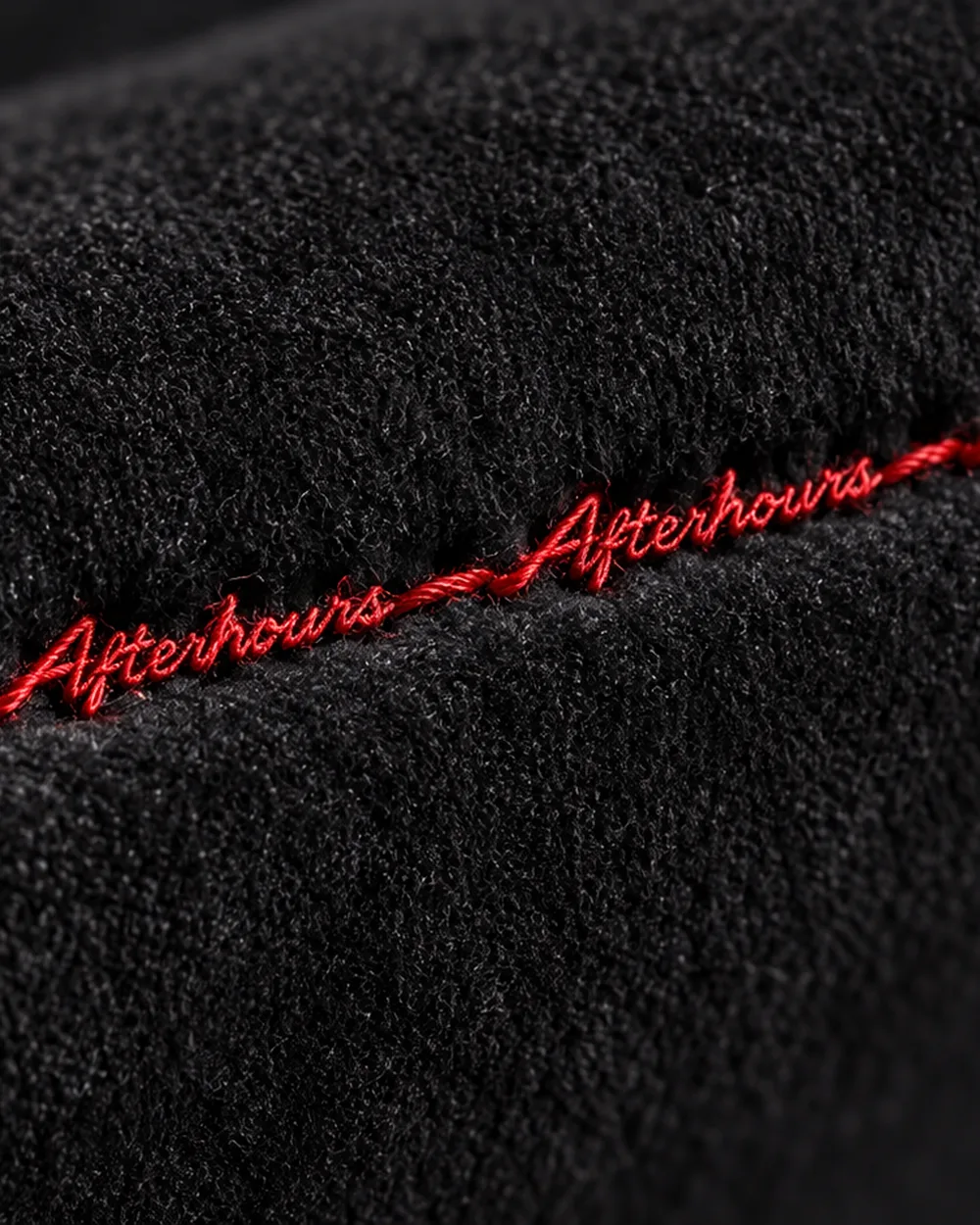 Black Alcantara with Afterhours stitched in red script along the seam