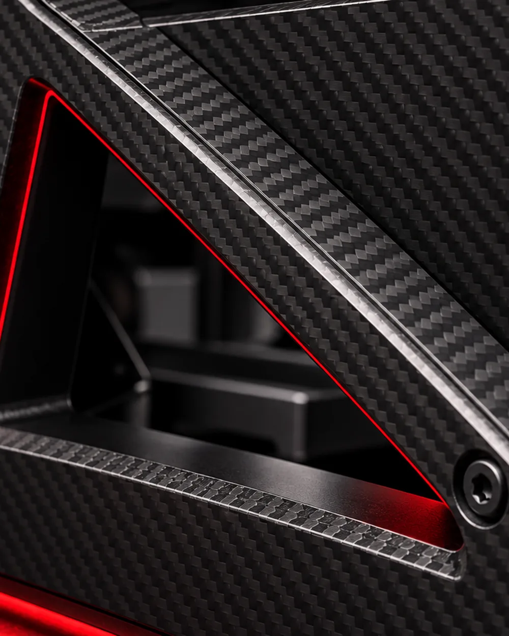 Satin carbon fibre on a chamfered panel edge, a red light along the cut-out and a Torx screw