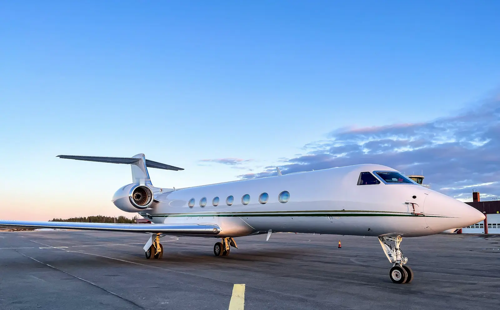 A large-cabin Gulfstream jet on the apron at dusk
